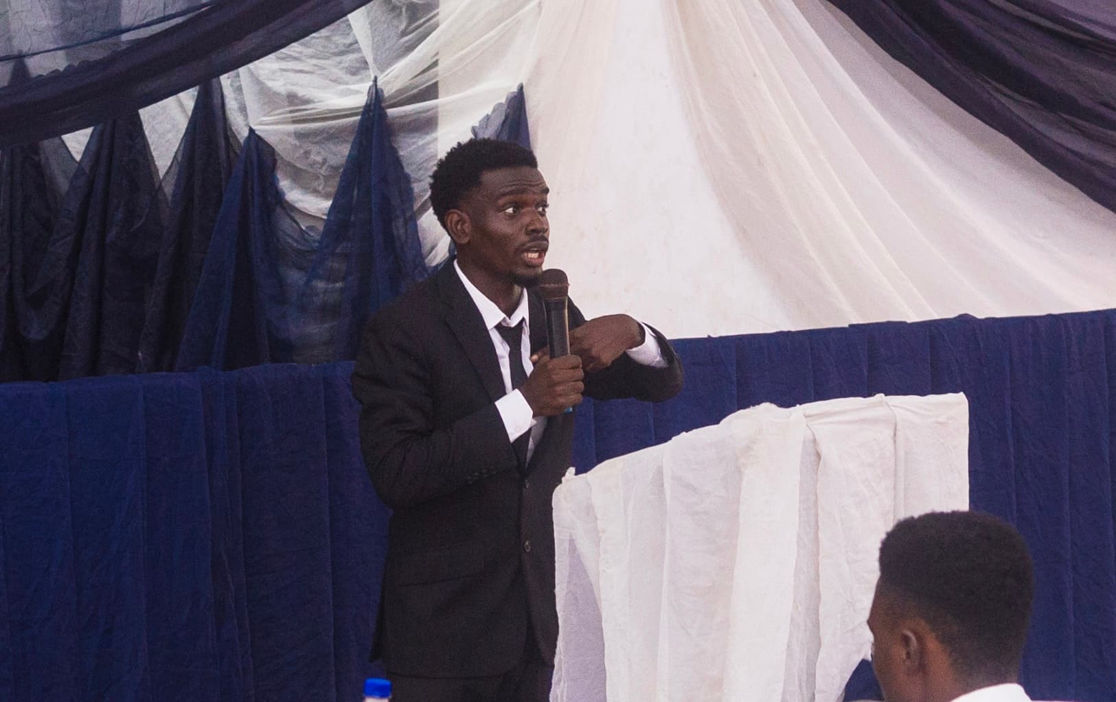 Speaking on stage during the competition