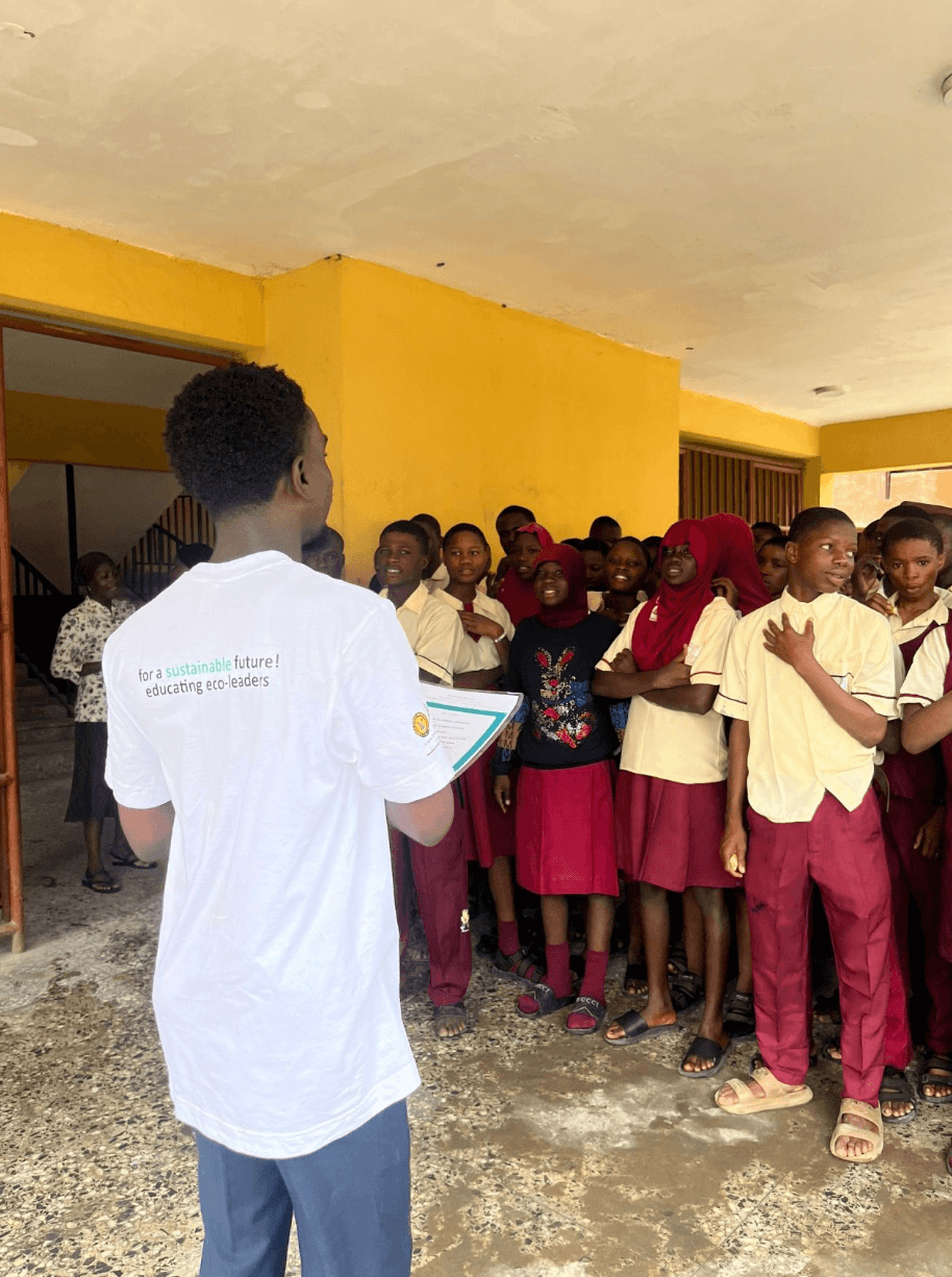 Speaking with students during a school visit.
