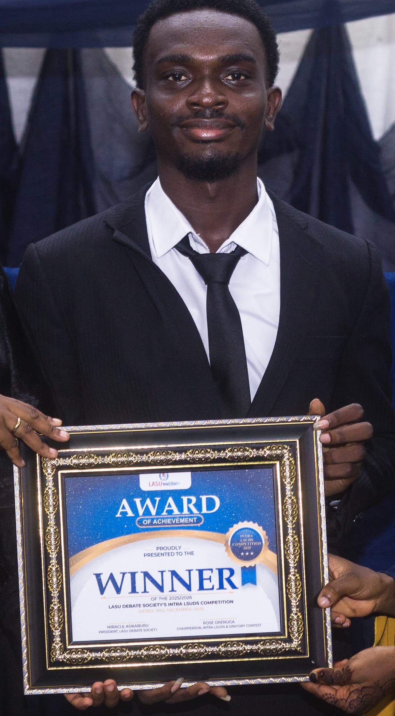 Holding the winner's Award of Achievement.